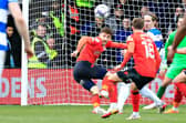 Tom Lockyer heads the ball clear against QPR