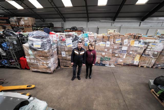 Irina Slisarenko and Michhaylo Ohal in front of part of the huge aid shipment - Photo Tony Margiocchi