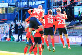 Luton's players celebrate James Collins' winning penalty against Watford