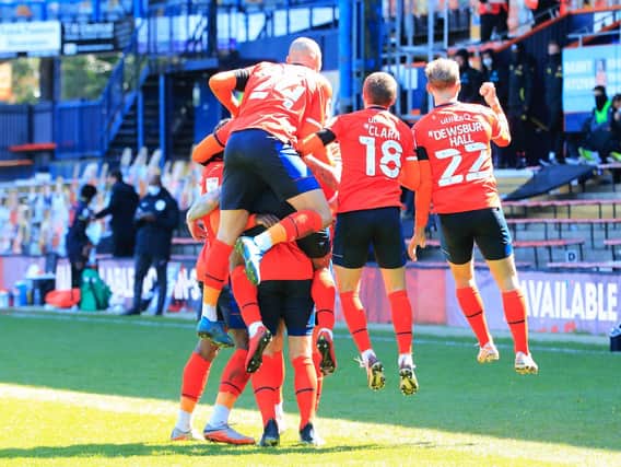 Luton's players celebrate James Collins' winning penalty against Watford
