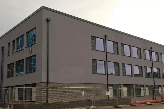 The new building adjoins the site of the current school