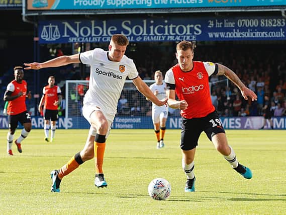 Reece Burke goes up against former Luton striker James Collins during Hull's 3-0 win at Luton in September 2019