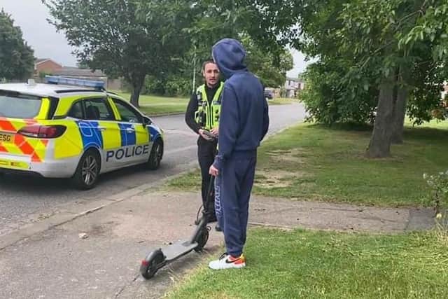 Police educate a rider about the laws surrounding e-scooters