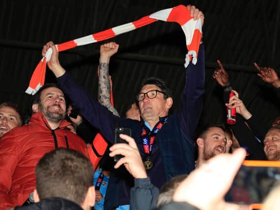Mick Harford celebrates winning the League One title in 2019