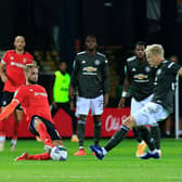 Andrew Shinnie slides in to make a challenge against Manchester United last season