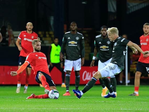 Andrew Shinnie slides in to make a challenge against Manchester United last season