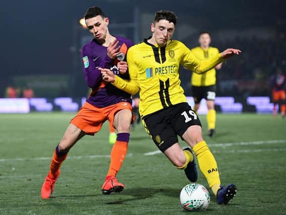Reece Hutchinson challenges Phil Foden during Burton Albion's EFL Cup semi-final defeat to Manchester City in January 2019