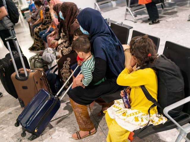 Afgan refugees wait to be processed after arriving on an evacuation flight from Afghanistan, at Heathrow Airport