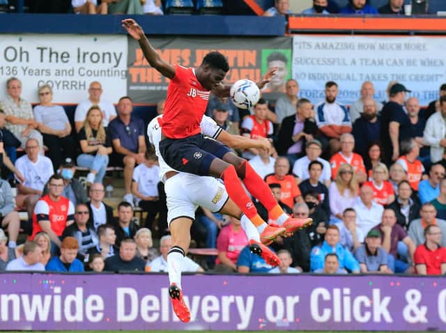 Elijah Adebayo rises to win a header against Swansea
