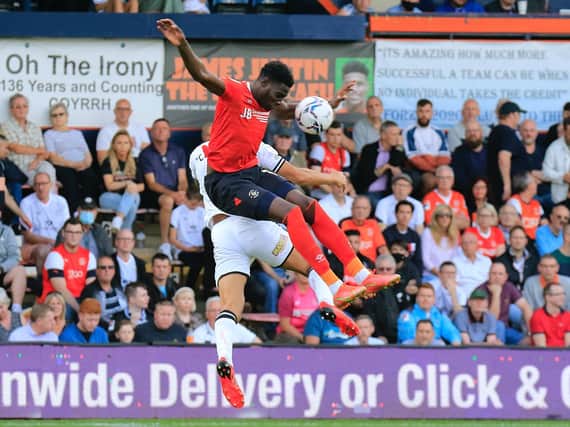 Town striker Elijah Adebayo goes up for a header against Swansea
