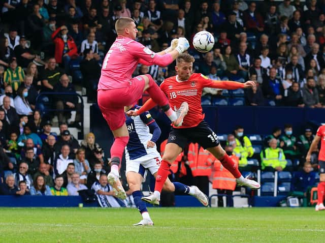 Jordan Clark is clattered by West Bromwich Albion keeper Sam Johnstone at the Hawthorns