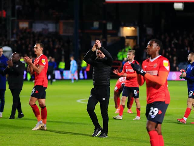 Hatters boss Nathan Jones applauds the Town fans after hammering Coventry City 5-0 on Wednesday night