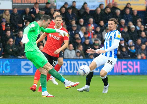 Simon Sluga clears the danger against Huddersfield
