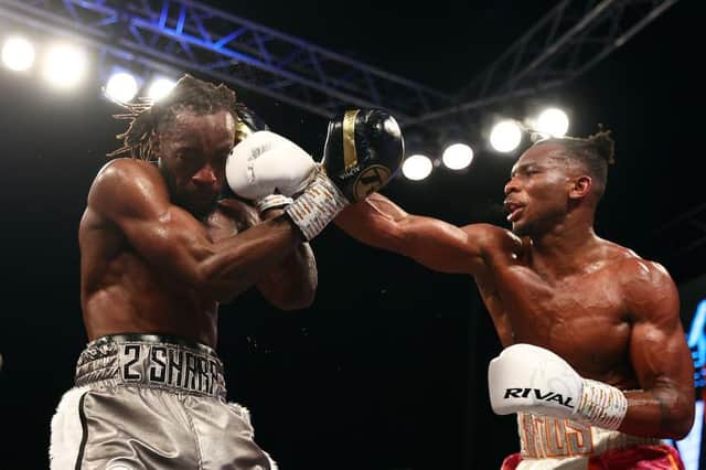 Linus Udofia lands a punch on Denzel Bentley during their British Middleweight title fight at the O2 Arena