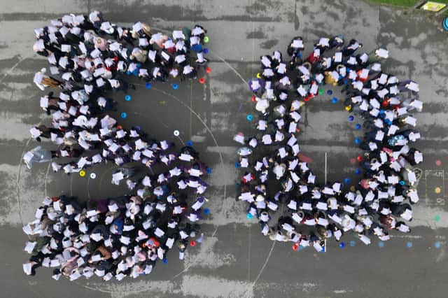 A drone image of pupils forming a giant 50 on the playground