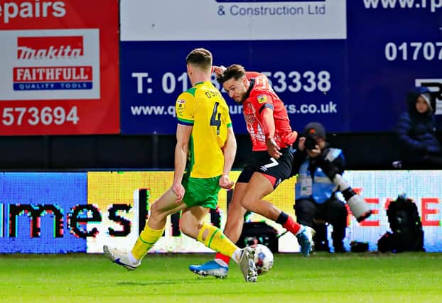 Luton attacker Harry Cornick delivers a cross against WBA recently