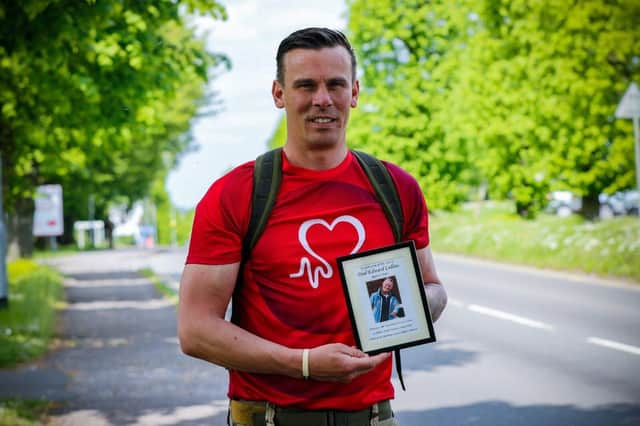 Soldier Stuart Collins with a picture of his dad Paul. 