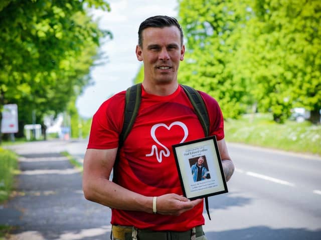 Soldier Stuart Collins with a picture of his dad Paul. 