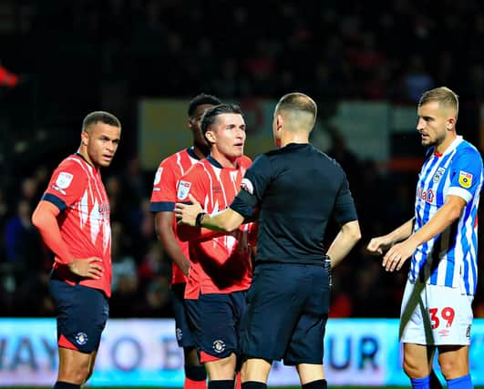 Dan Potts complains to referee Leigh Doughty after conceding a penalty in the 3-3 draw with Huddersfield last night