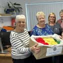 Dunstable Inner Wheel members deliver their gifts of hats.