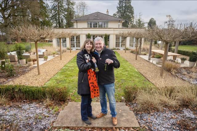 Winner Michael with his wife, Amanda, outside their new home. Picture: Omaze