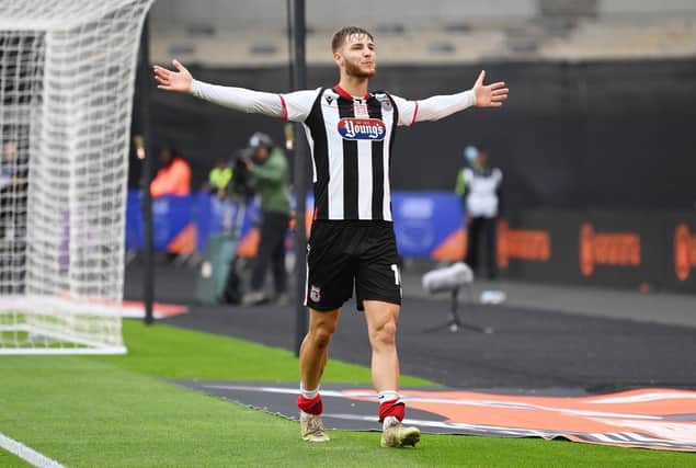John McAtee celebrates scoring for Grimsby in the play-off final against Solihull Moors