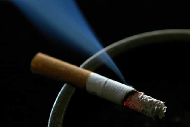 A cigarette burning on an ash tray. Picture: Gareth Fuller/PA.