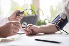 Doctor checking the blood pressure of a patient