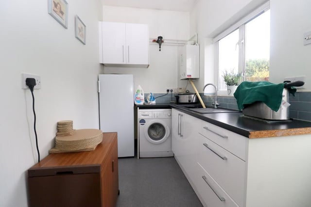 The kitchen allows access into a separate utility room, which in turn allows access to the garage and also to the rear.