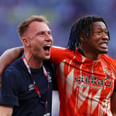 Gabe Osho celebrates winning promotion to the Premier League with Hatters team-mate Cauley Woodrow