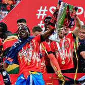Hatters midfielder Pelly-Ruddock Mpanzu celebrates with the trophy