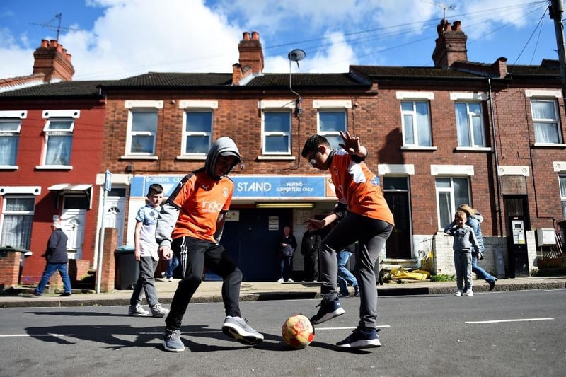 Two young Luton Town fans play football outside the stadium before the Sky Bet League One match between Luton Town and Oxford United at Kenilworth Road on May 04, 2019.