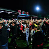 Luton fans take to the field to celebrate reaching Wembley on Tuesday night