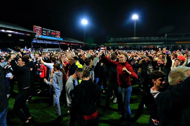Luton fans take to the field to celebrate reaching Wembley on Tuesday night