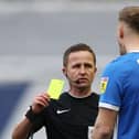 Marc Roberts is shown a yellow card by referee David Webb this afternoon