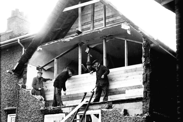 Workmen boarding up the front of a house in Crookes after the gales had blown out the complete bedroom wall at the front of the house in 1962