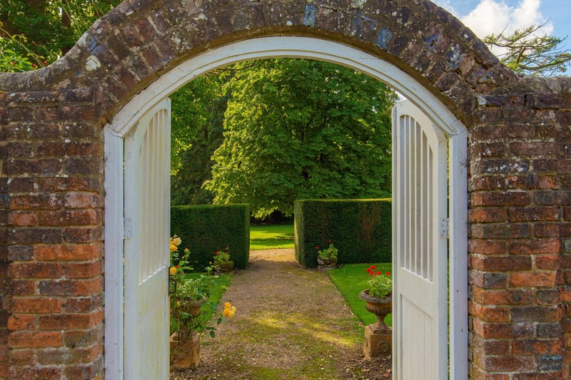 Here is the beautiful, partly walled rose garden to the west of the house that leads to the walled kitchen garden. This next garden has its own an orchard, various raised beds with three greenhouses and a workshop to do all your DIY projects. Maybe you'll restore your vintage car in the workshop?