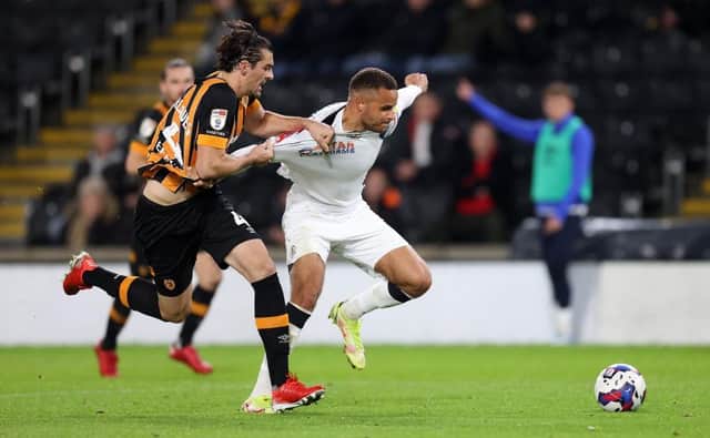 Carlton Morris looks to get away from Hull defender Jacob Greaves recently