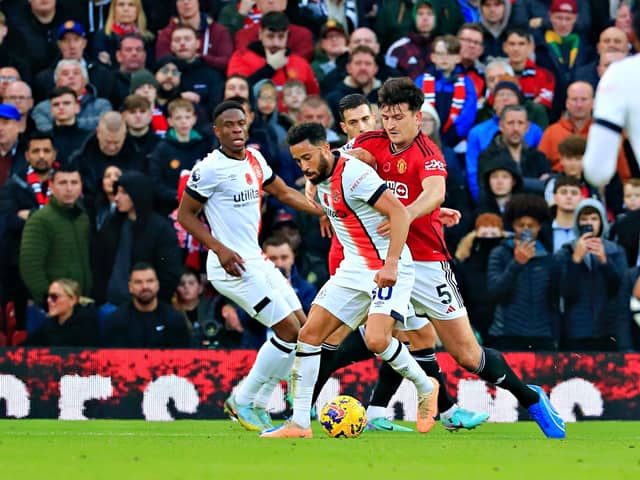 Andros Townsend looks to get away from Manchester United defender Harry Maguire on Saturday - pic: Liam Smith