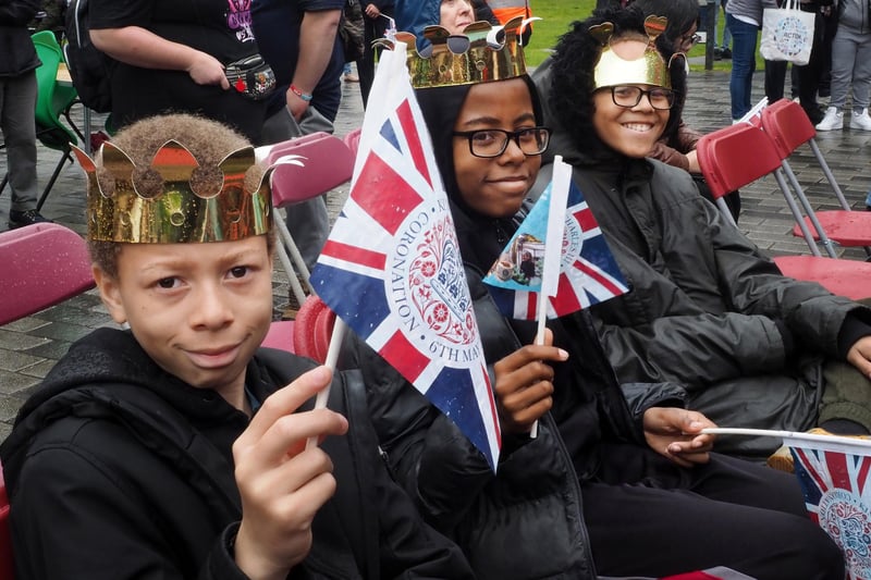 These youngsters wore their gold crowns and waved flags while they watched the ceremony