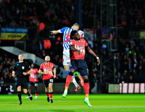 Town striker Elijah Adebayo goes up for a header against Huddersfield on Tuesday night