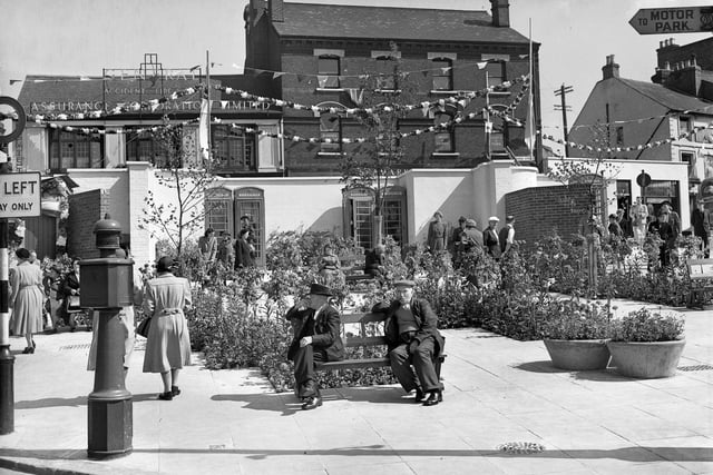 Luton’s Corn Exchange was demolished in 1994, but in this picture, two men sit in front of its glorious bunting.