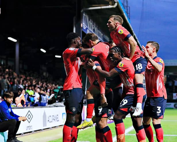 Carlton Morris is mobbed after scoring against Sheffield United this evening