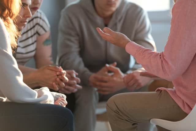 Close-up of a therapist talking to a group of teenagers. Picture: Ground Picture/Shutterstock