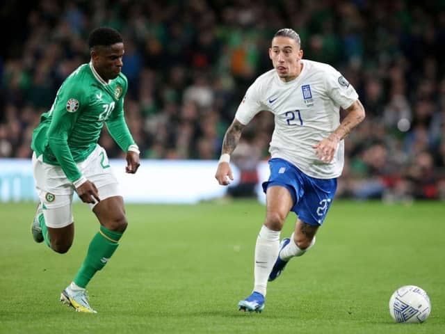 Chiedozie Ogbene tracks Greece defender Kostas Tsimikas during Ireland's 2-0 defeat in Dublin - pic: PAUL FAITH/AFP via Getty Images