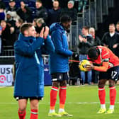 Town hat-trick hero Elijah Adebayo is handed the match ball by team-mate Pelly Ruddock Mpanzu - pic: Liam Smith