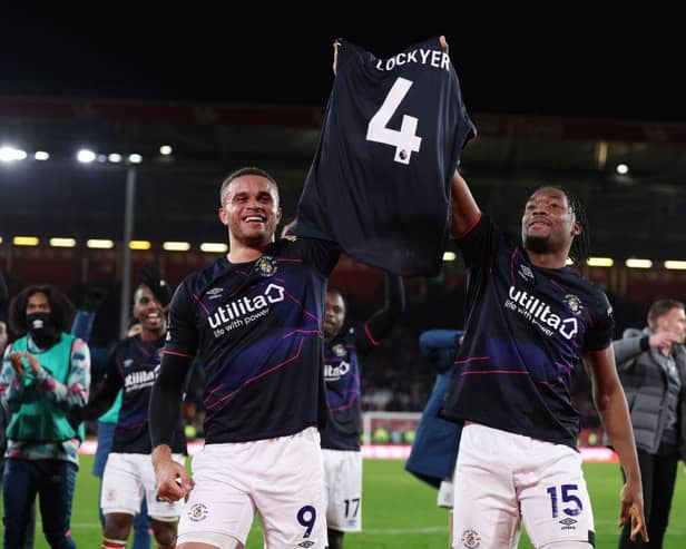 Carlton Morris and Teden Mengi hold Tom Lockyer's shirt aloft after a terrific 3-2 win at Sheffield United this afternoon - pic: George Wood/Getty Images