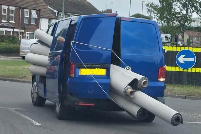 The van pictured with multiple rolls of carpet sticking out of the side and rear doors. (Pictured: Bedfordshire, Cambridgeshire and Hertfordshire Road Policing Unit via Twitter)