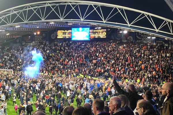 Huddersfield Town fans goad the Luton supporters at the full time whistle this evening