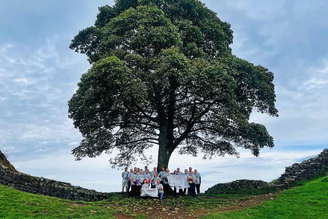 The Keech Hospice Team standing in front of the iconic sycamore tree before it was vandalised